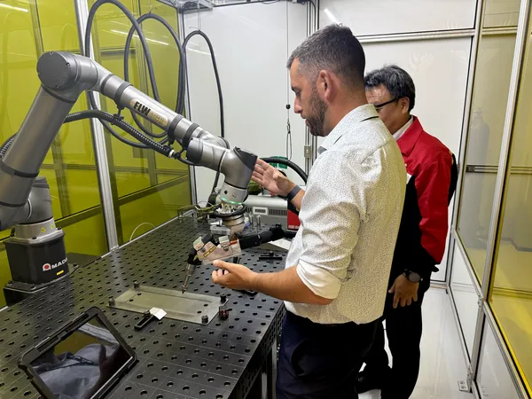 Ingeniero de aplicaciones demostrando la celda de soldadura robótica colaborativa